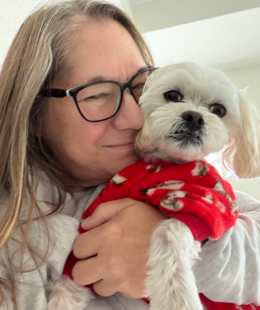 Lynn holding her small dog Clifford